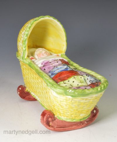 Pearlware pottery child's toy cradle with sleeping girl, circa 1820