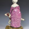 Staffordshire pearlware figure mother giving her child a ride on a dog, circa 1820