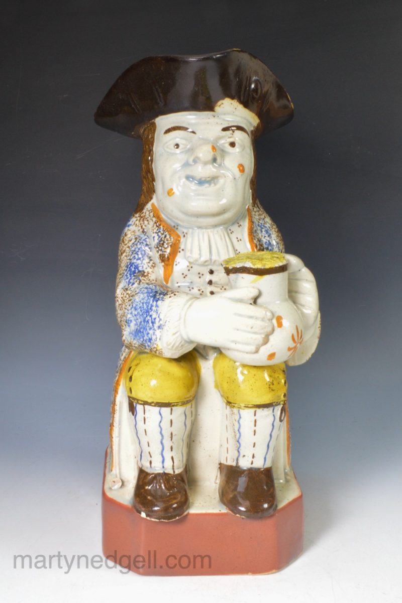 Pearlware pottery Toby Jug decorated with underglaze enamels, circa 1820