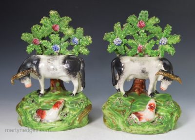 Pair of Staffordshire pearlware pottery bocage cow groups, circa 1820
