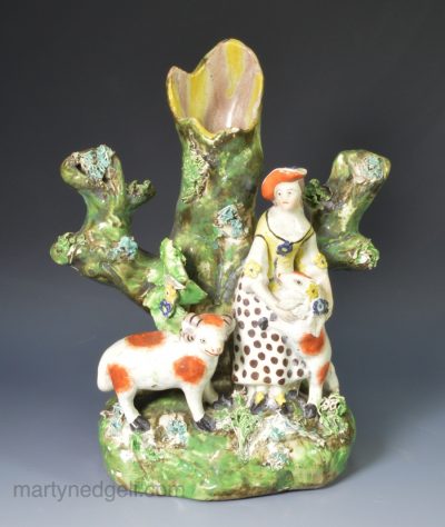 Staffordshire pearlware pottery figural spill vase a woman with her pet sheep, circa 1820