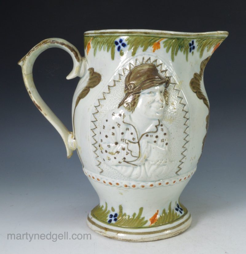 Prattware pottery jug moulded with the "Miser", circa 1820