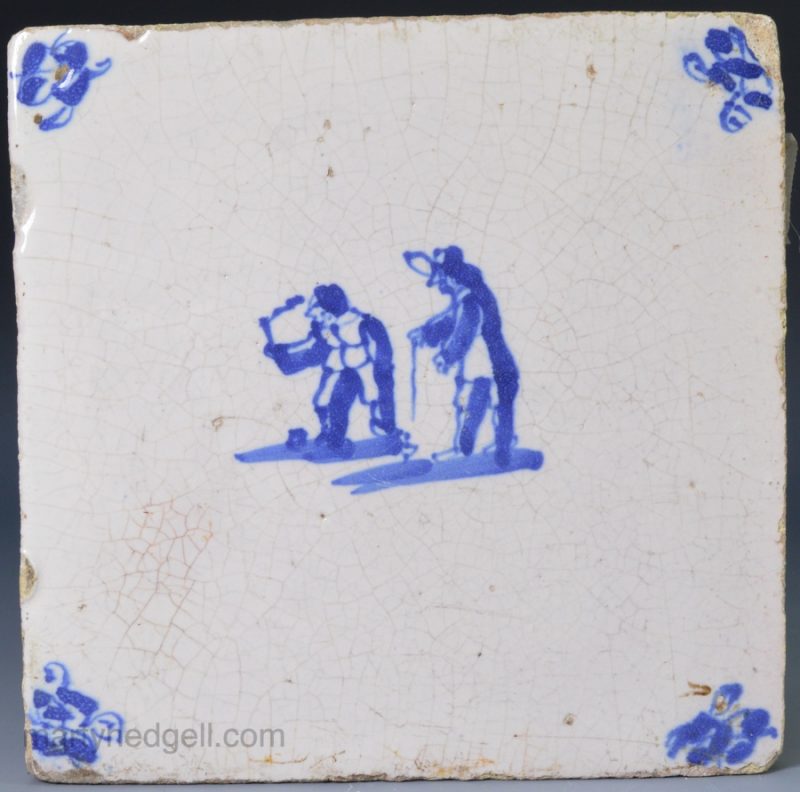 Dutch Delft tile painted with boys playing with tops, circa 1750
