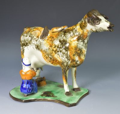 Pearlware pottery cow creamer decorated with high fired enamels under the glaze, circa 1820