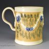 Creamware pottery mug decorated with tan slip and blue sponging, circa 1790