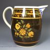 Pearlware pottery jug decorated with high fired enamels over a dark brown slip, circa 1820, perhaps Scottish