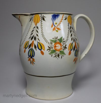 Pottery serving jug decorated with high fired enamels under a pearlware glaze (Prattware), circa 1820