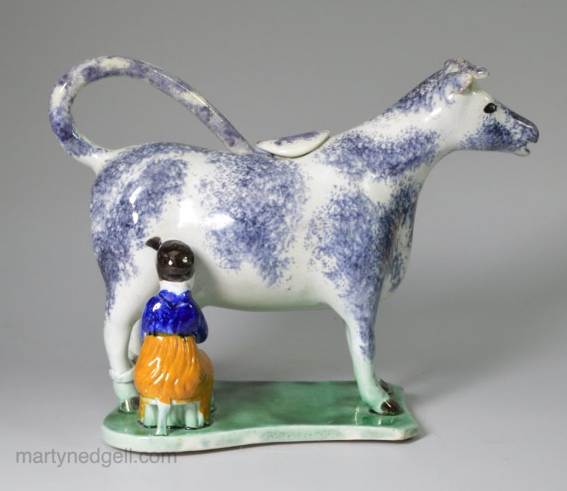 Pottery cow creamer decorated with high fired enamels under a pearlware glaze, prattware, circa 1820