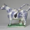 Pottery cow creamer decorated with high fired enamels under a pearlware glaze, prattware, circa 1820