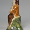 Pottery figure decorated with high fired enamels under a pearlware glaze, circa 1800