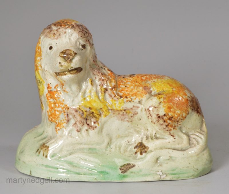 Prattware pottery lion decorated with high fired enamels under a pearlware glaze, circa 1820