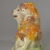 Prattware pottery lion decorated with high fired enamels under a pearlware glaze, circa 1820