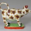Pearlware pottery cow creamer decorated with overglaze enamels, circa 1820