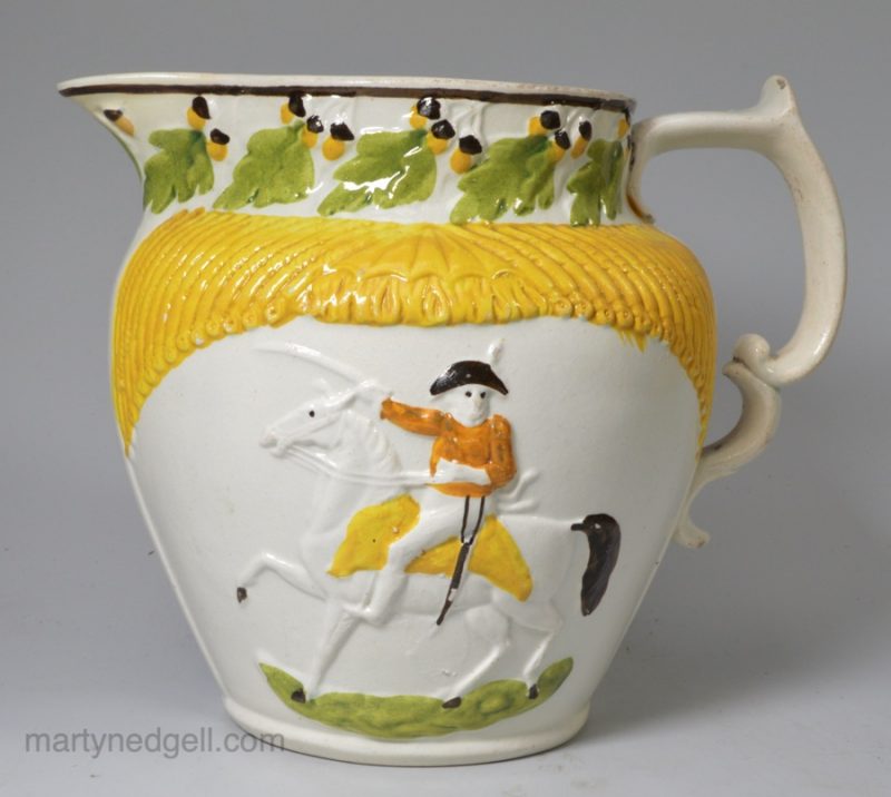 Pearlware pottery jug moulded with Wellington on horse back and decorated with high fired enamels under the glaze, circa 1810