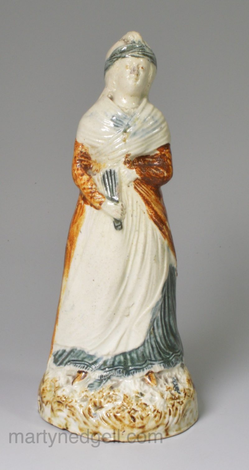 Creamware pottery figure decorated with enamels under the glaze, circa 1800