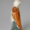 Creamware pottery figure decorated with enamels under the glaze, circa 1800