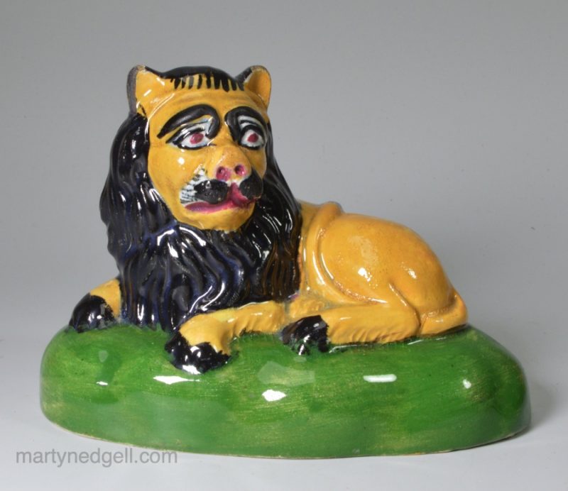 Pottery lion decorated with high fired enamels under a pearlware glaze, circa 1820, possibly Scottish or North East pottery