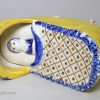 Prattware pottery child in a cradle, circa 1800, probably Bovey Tracey Pottery