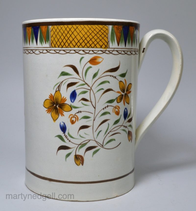 Prattware pottery quart tankard decorated with high fired enamels under a pearlware glaze, circa 1820