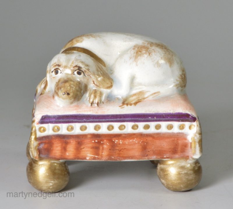 Pearlware pottery spaniel on a cushion, circa 1820