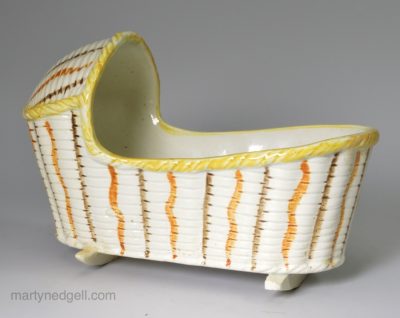 Prattware pottery toy cradle decorated with high fired enamels under a pearlware glaze, circa 1820