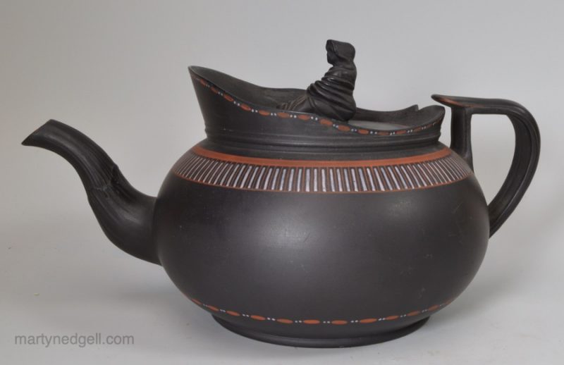 Staffordshire black basalt teapot with encaustic decoration, circa 1790, with a fake Wedgwood mark