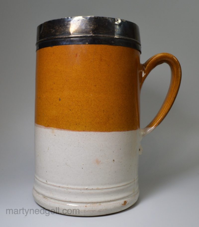Staffordshire turned stoneware half gallon mug dipped in white slip and the top half with iron wash, circa 1700-1720