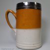 Staffordshire turned stoneware half gallon mug dipped in white slip and the top half with iron wash, circa 1700-1720