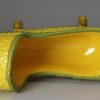 Canary yellow pottery toy cradle, circa 1820