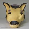 Buff coloured pottery fox head stirrup cup, circa 1820