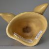 Buff coloured pottery fox head stirrup cup, circa 1820