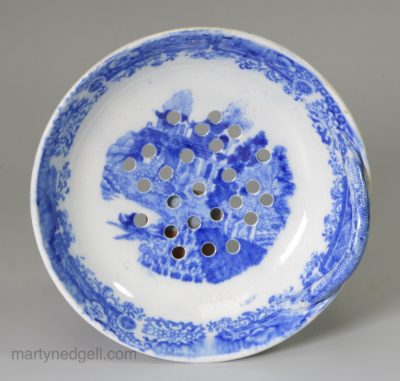 Pearlware pottery strainer decorated with blue transfer under the glaze, circa 1820