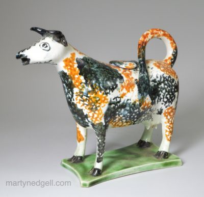 Prattware pottery cow creamer decorated with high fired enamels under a pearlware glaze, circa 1820
