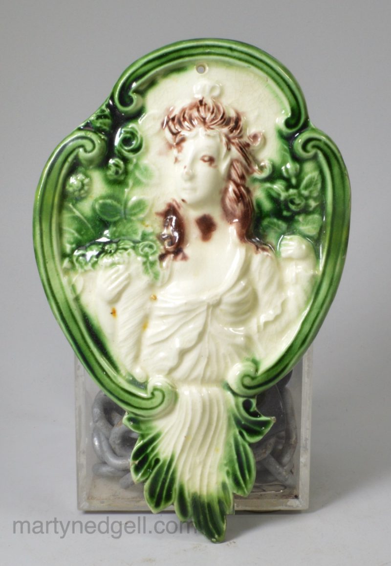Creamware pottery plaque moulded with Flora and decorated with coloured glazes, circa 1780 possibly Bovey Tracey Pottery