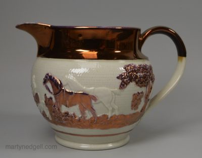 Stoneware jug moulded with a hunting scene and decorated with pink and copper lustre, circa 1830