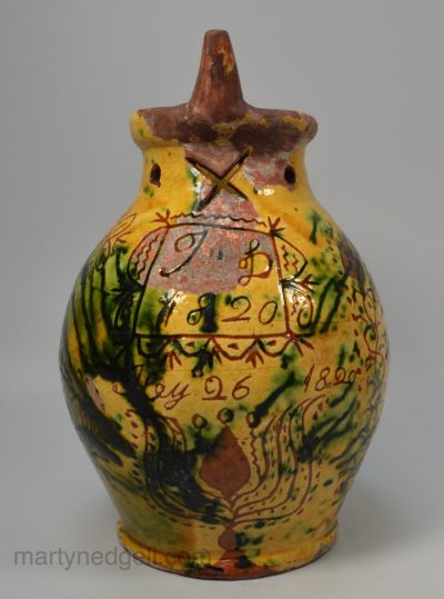 Donate pottery puzzle jug decorated with sgraffito work, dated 1820
