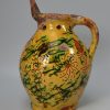 Donate pottery puzzle jug decorated with sgraffito work, dated 1820