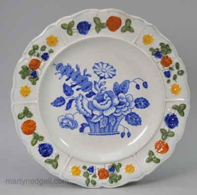 Prattware pottery child's plate decorated with a blue transfer print under a pearlware glaze, circa 1820