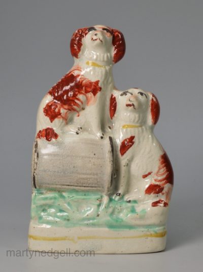 Staffordshire pottery model of spaniels one on a barrel, circa 1870