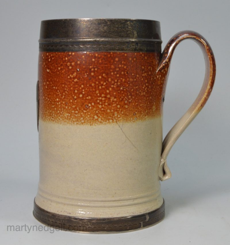Fulham salt glaze stoneware tankard with a glass bottom, silver mounts and crest, circa 1720