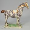 Pearlware pottery horse decorated with underglaze enamels, circa 1820