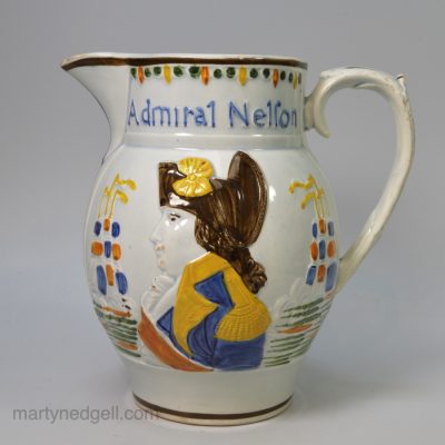 Commemorative pearlware pottery jug moulded with portraits of Admiral Nelson and Captain Berry and coloured with Pratt type enamels under the glaze, circa 1805