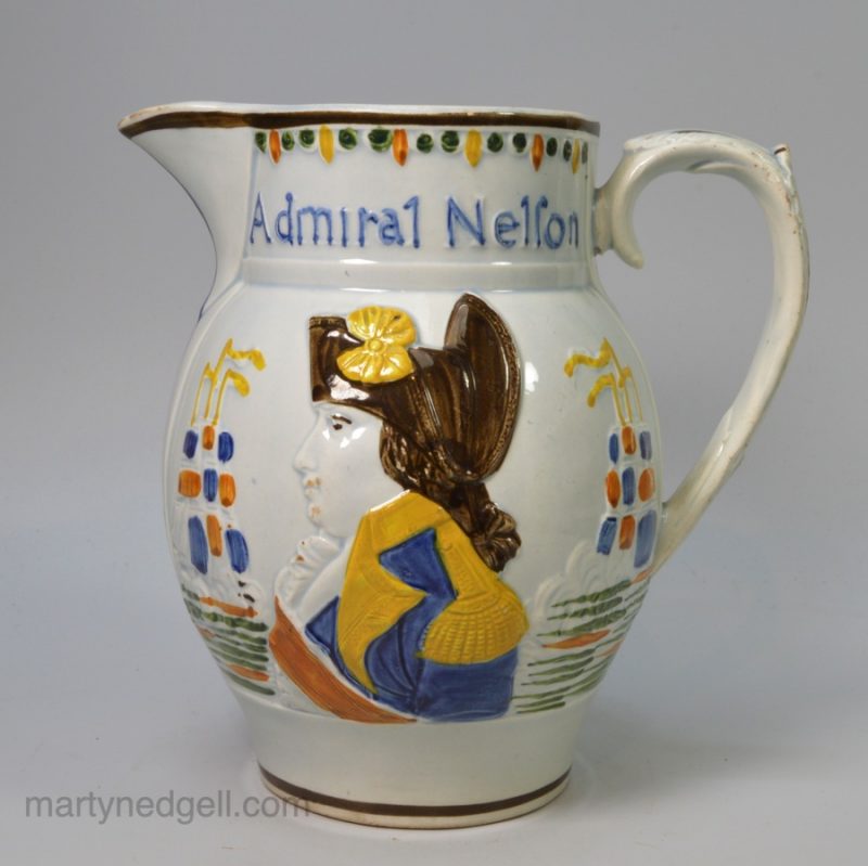 Commemorative pearlware pottery jug moulded with portraits of Admiral Nelson and Captain Berry and coloured with Pratt type enamels under the glaze, circa 1805
