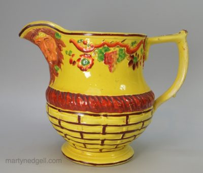 Canary yellow jug moulded with bacchanalian faces, circa 1820