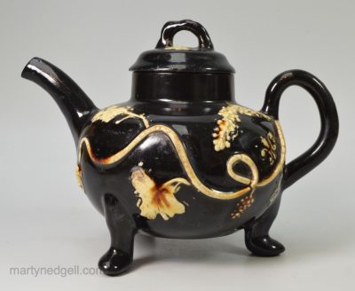 Staffordshire Jackfield black teapot decorated with cream coloured sprigs, circa 1770