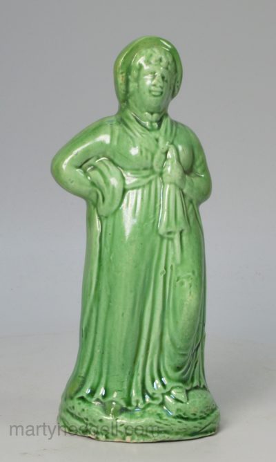 Creamware green glazed figure of a woman, circa 1790