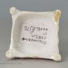 Small Staffordshire porcelain spaniel on a cushion, circa 1830