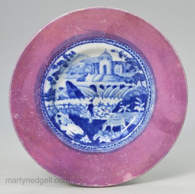 Pearlware pottery cup plate decorated with a transfer print in blue and a lustre border, circa 1820