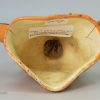 Buff coloured pottery stirrup cup decorated with manganese, circa 1800