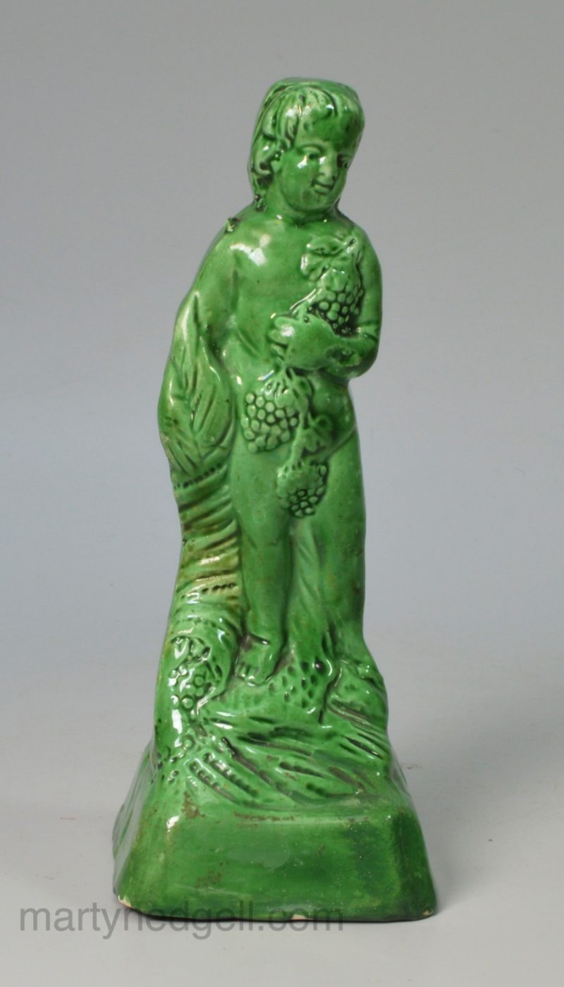 Green glazed creamware pottery figure of Bacchus, circa 1800